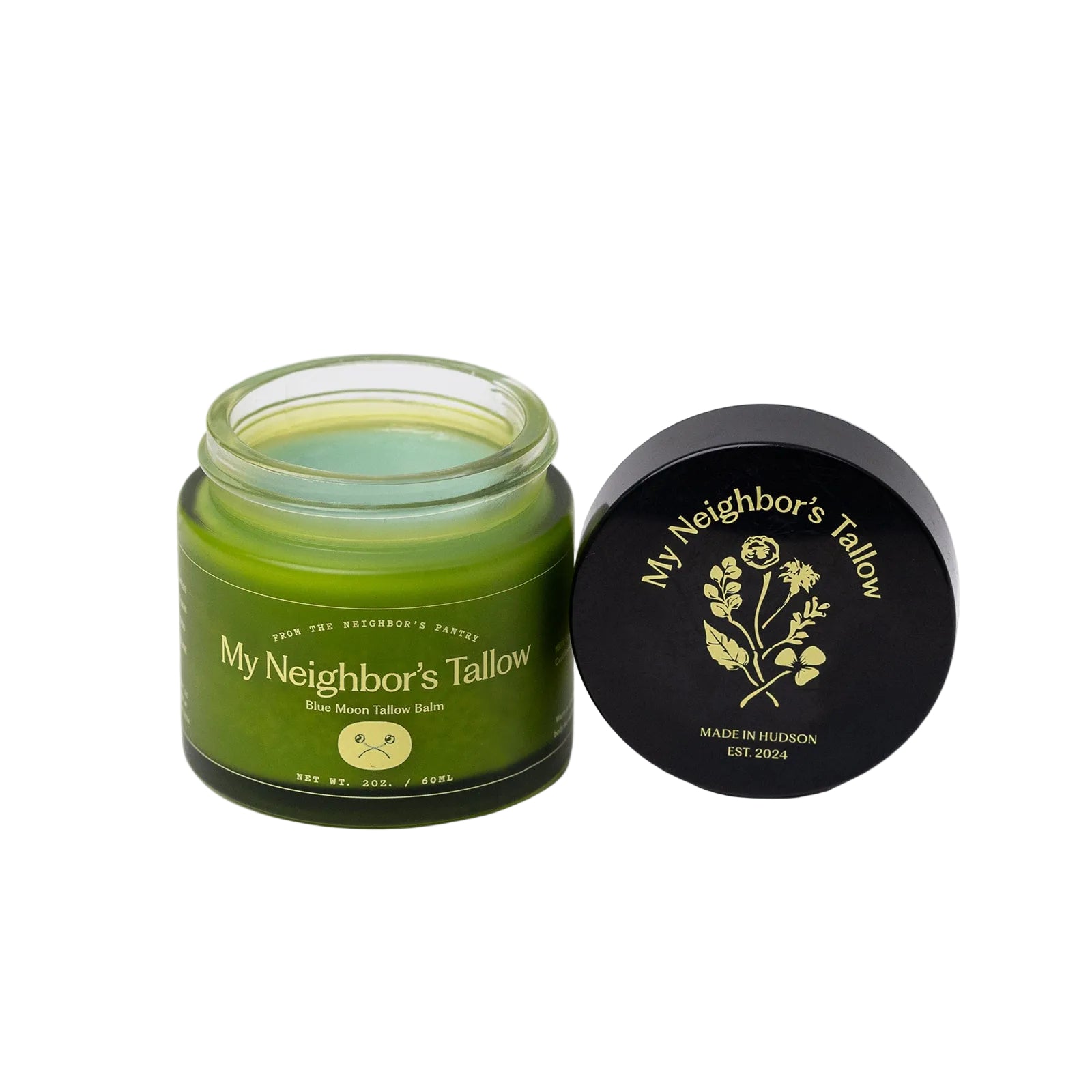 Green jar of 'My Neighbor's Tallow' balm with black lid on a white background